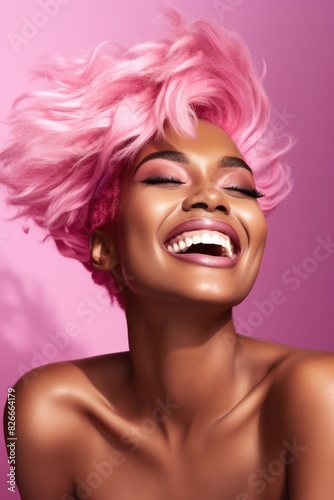 A woman with pink hair is smiling and laughing. She has a pink and white background. Scene is happy and cheerful