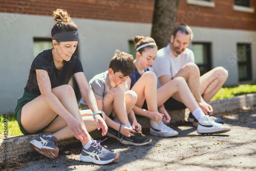 A Family exercising and jogging together at an outdoor park having great fun