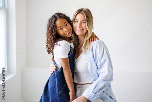 An Adorable black american little girl with her mother on studio
