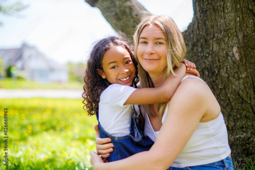 Black American child is playing with her mother while having a summer picnic in the public park. Black American child is playing with her mother while having a summer picnic in the public park.