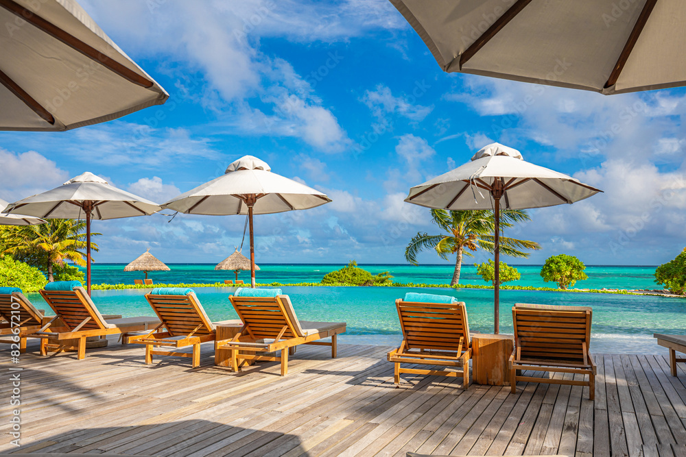 Stunning landscape, swimming pool blue sky with clouds. Tropical resort hotel in Maldives. Fantastic relax and peaceful vibes, chairs, loungers under umbrella and palm leaves. Luxury travel vacation
