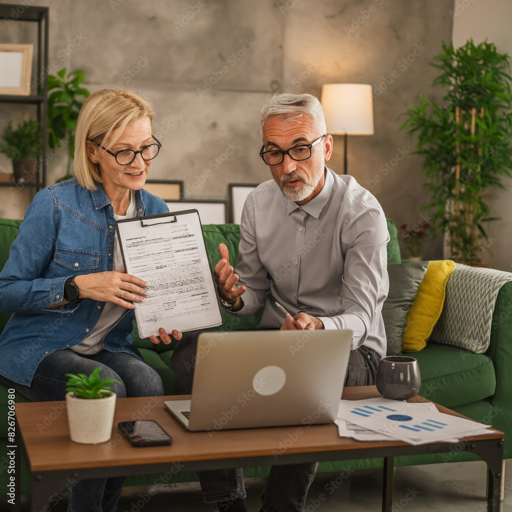 Mature man and woman work form home have consultation via video call Mature man and woman work form home have consultation via video call