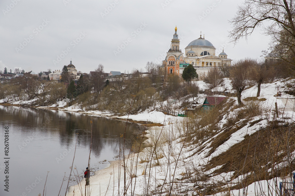 Tvertsa river in the city of Torzhok in Russia. On the shore there is an old temple from the 18th century.