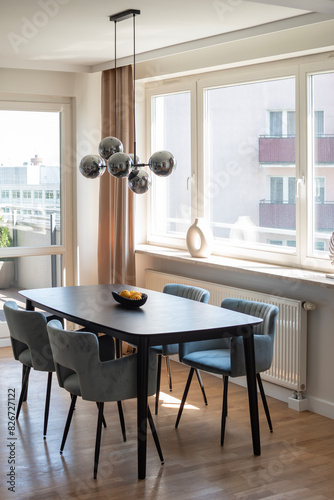 Dining room with lemons on the table, modern light fixture in modern apartment