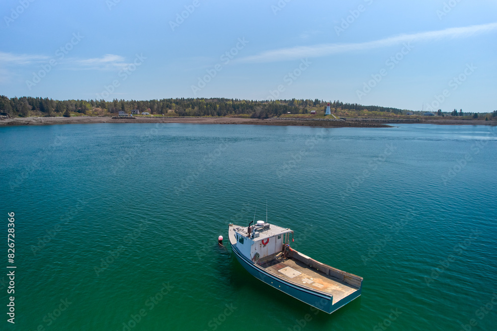 Aerial Drone images of the Lobster fishing fleet out of Lubec Maine on Johnsons Bay which is on the Canadian Border with the Mulholland Lighthouse in Canada in the background