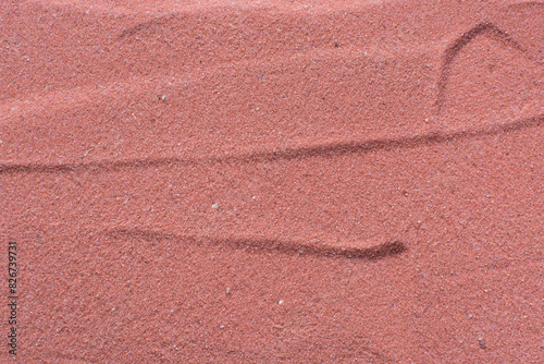 Lines drawn in pink sand background, beautiful sand texture, overhead view of pink sand, zen pattern drawn in the sand, Top view of fine grain texture photo