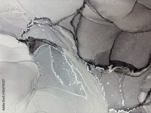 Abstract grey marble with silver — fluid art background with potal, stone texture made with alcohol ink. Big black and white natural marble backdrop resembles silver watercolor or aquarelle.

