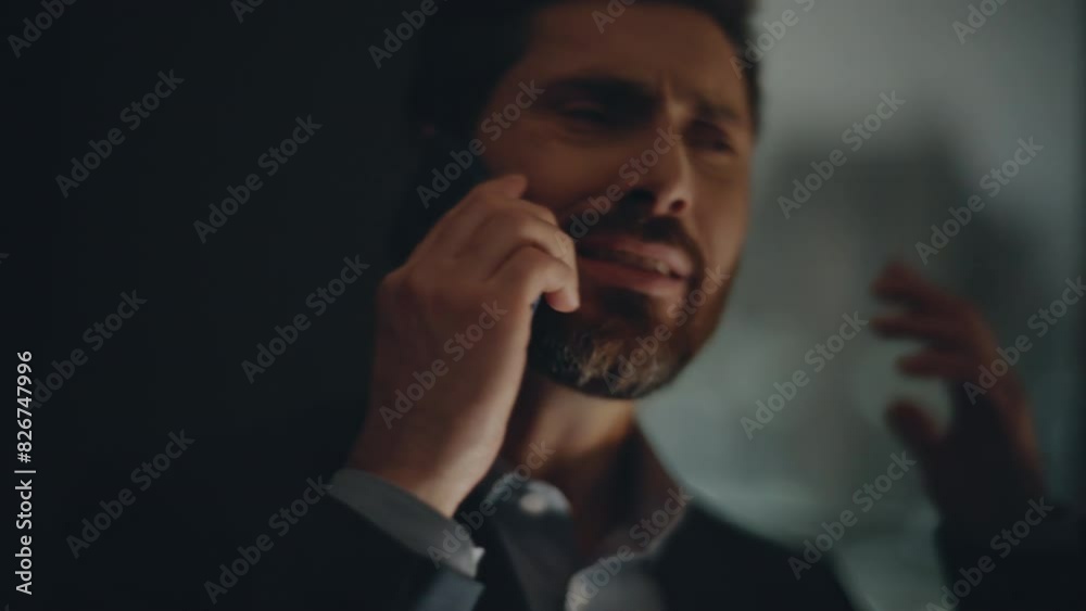 Annoyed man calling smartphone gesturing hand in evening windows room closeup Annoyed man calling smartphone gesturing hand in evening windows room closeup