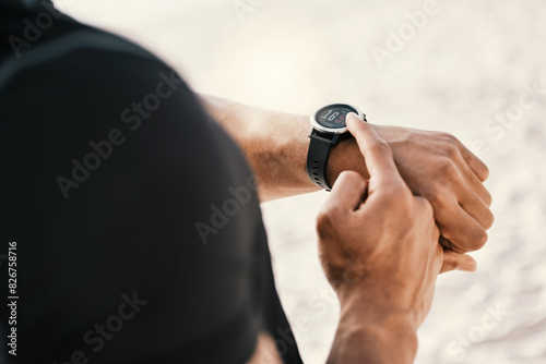 Fitness, hands of person and watch on beach for running stats, cardio progress or marathon training in outdoor. Closeup, sports and athlete with digital tech for wellness, monitor workout or exercise