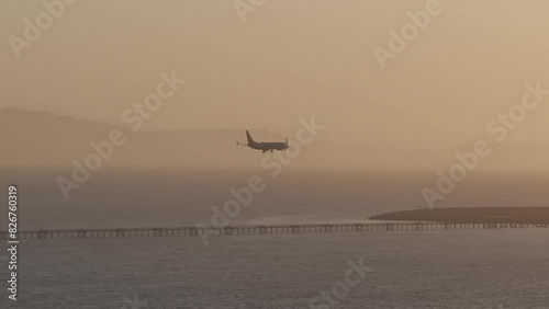 Aerial view of a plane landing at San Leandro Airport at sunset, USA photo