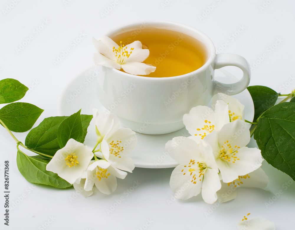 Cup with green tea and jasmine flowers on a white background. Horizontal