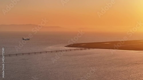 Aerial view of a plane landing at San Leandro Airport at sunset, USA photo