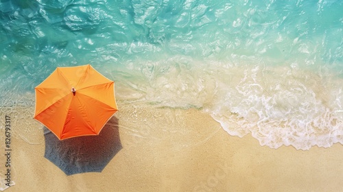 A beach umbrella is sitting on the sand next to the ocean