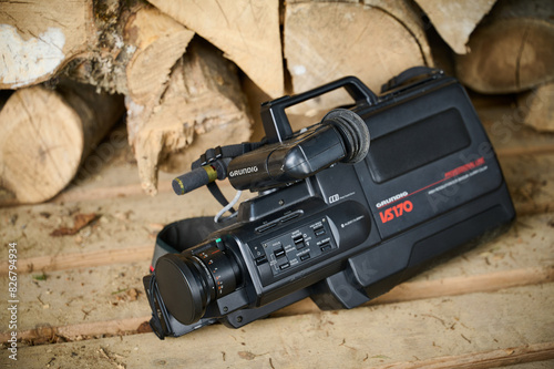 Ukraine 11.04.2024. Grundig vhs170. Old vhs video camera near wooden logs and garbage. close-up. High quality photo