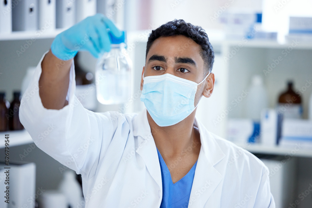 Science, glass and man with mask, liquid in container and medical research in laboratory. Vaccine innovation, scientist or lab technician with solution, bottle or pharmaceutical development with ppe Science, glass and man with mask, liquid in container and medical research in laboratory. Vaccine innovation, scientist or lab technician with solution, bottle or pharmaceutical development with ppe