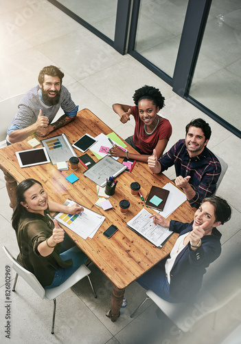 Thumbs up, business people and meeting in office for planning, subscription or company growth. Top view, diversity and employees with graphs for briefing, readership or hand gesture at publication