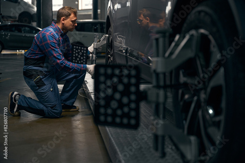 Man working with machine for wheel repair