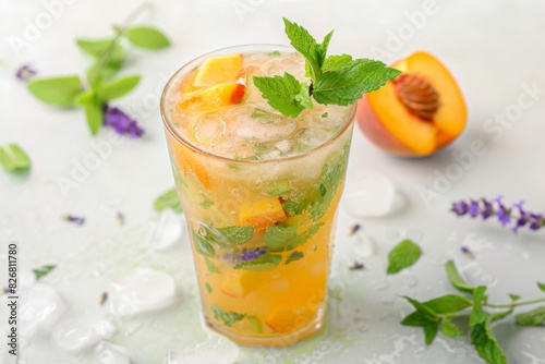 A refreshing peach mojito served with ice and fresh mint leaves on a table