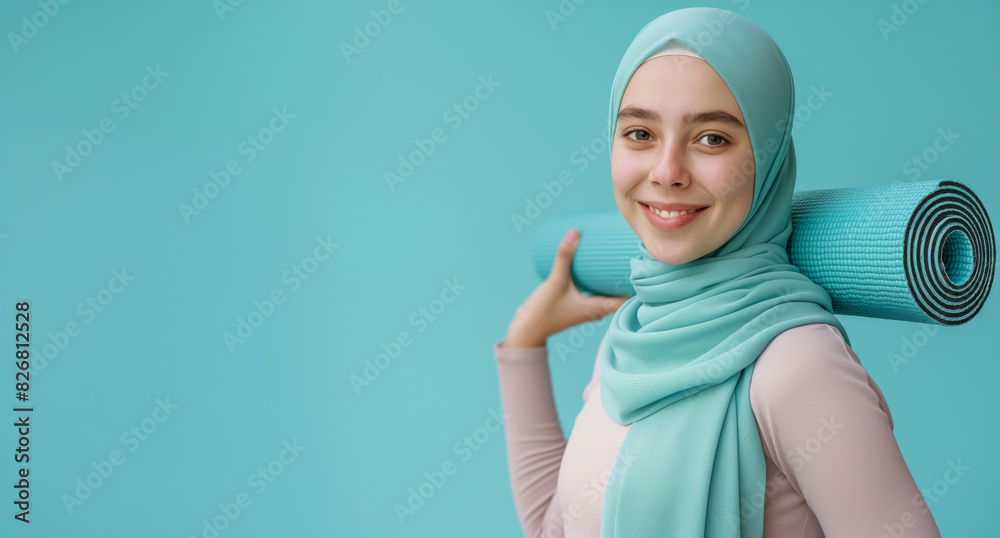 Smiling Muslim woman holding yoga mat, healthy lifestyle concept. Smiling Muslim woman holding yoga mat, healthy lifestyle concept.