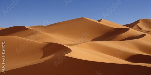 Sand dunes in a desert landscape under a clear blue sky