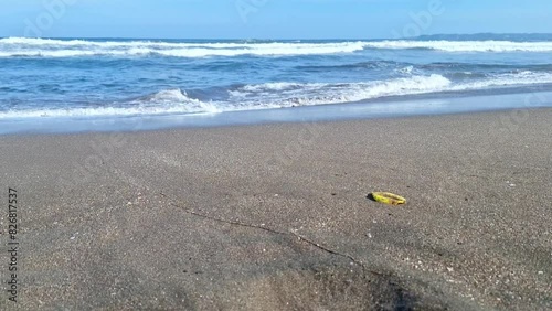 Panorama of a beautiful brown sand beach and turquoise water. Holiday summer beach background.. Wave of the sea on the sand beach.