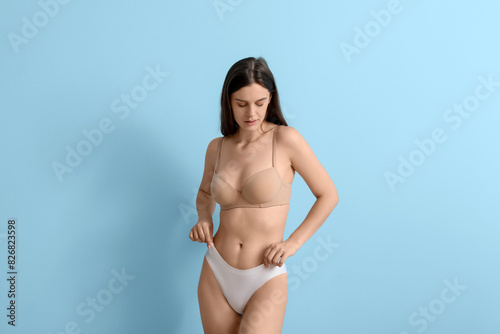 Body positive woman on blue...