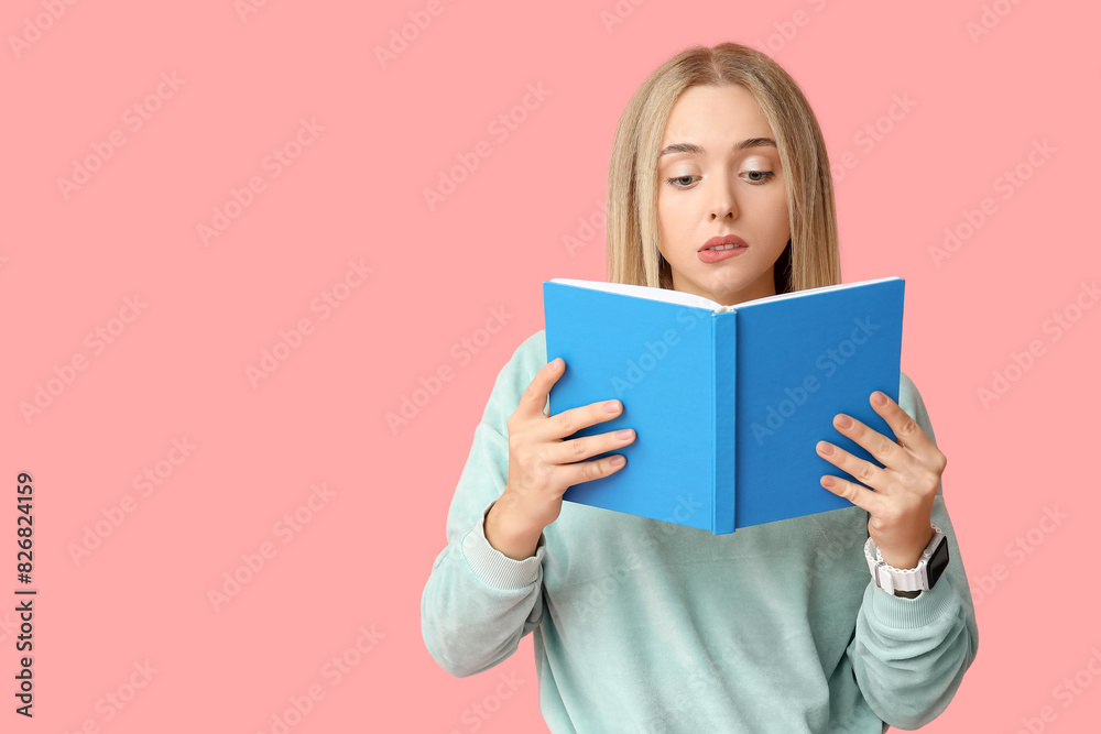 Beautiful young thoughtful woman with book on pink background Beautiful young thoughtful woman with book on pink background