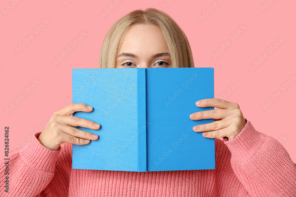 Beautiful happy young woman with book on pink background Beautiful happy young woman with book on pink background