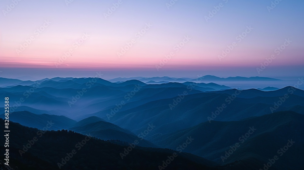 The image shows a beautiful mountain landscape with a sunrise or sunset sky The image shows a beautiful mountain landscape with a sunrise or sunset sky