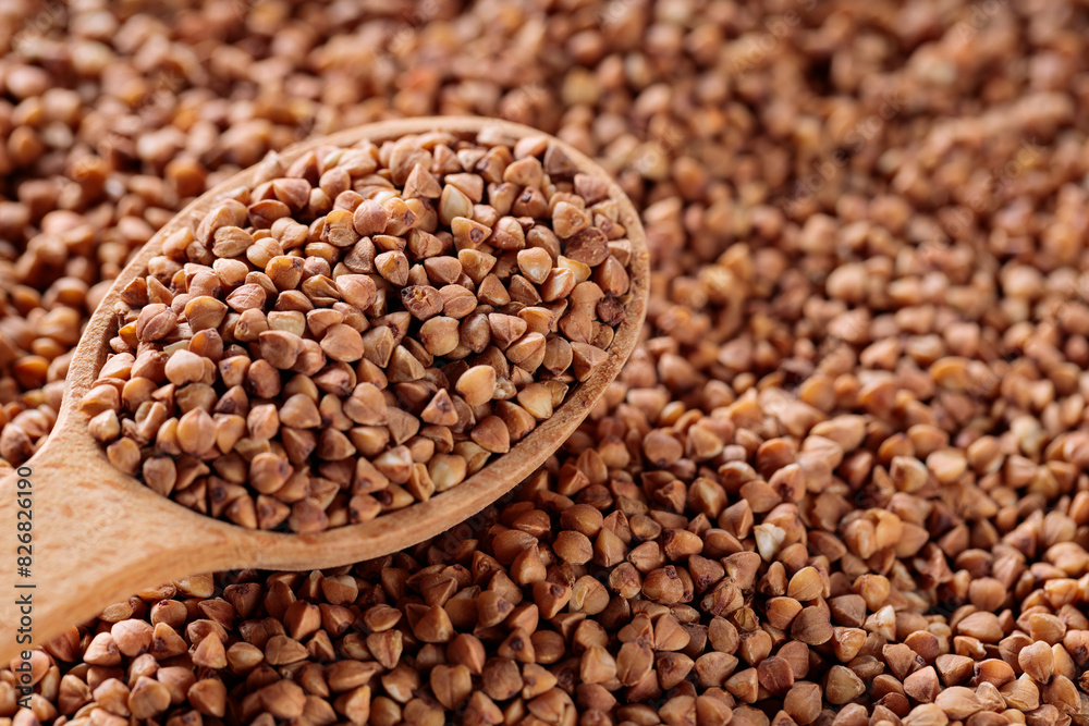 Scattered Dry Buckwheat with Wooden Spoon, Copy Space Scattered Dry Buckwheat with Wooden Spoon, Copy Space