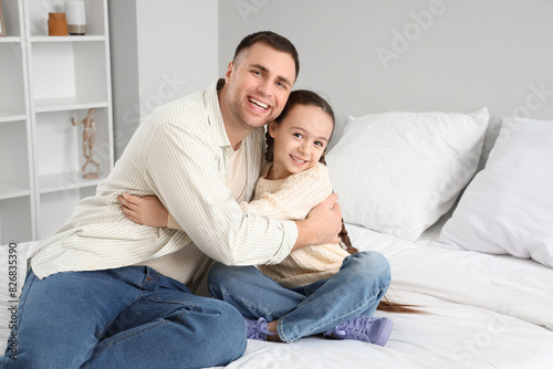 Father and his daughter hugging in bedroom