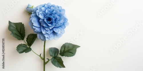 A blue artificial flower on a white background