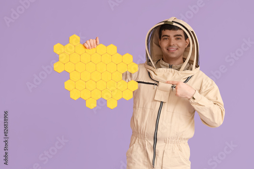 Male beekeeper pointing at ...