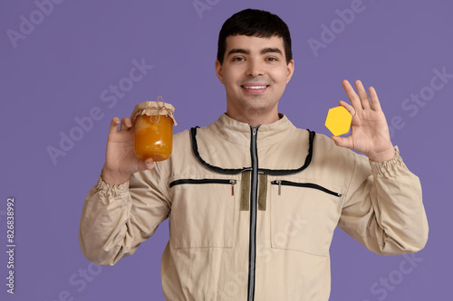 Male beekeeper with jar of ...