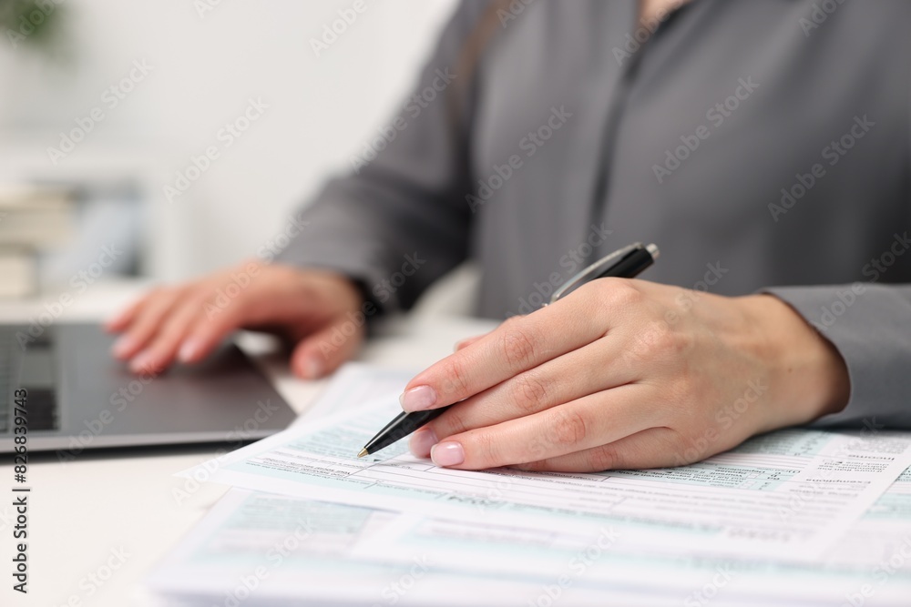 Secretary doing paperwork at table in office, closeup Secretary doing paperwork at table in office, closeup