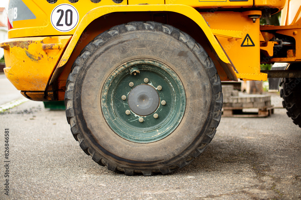 Side view of a large excavator tire. Construction site, nobody.