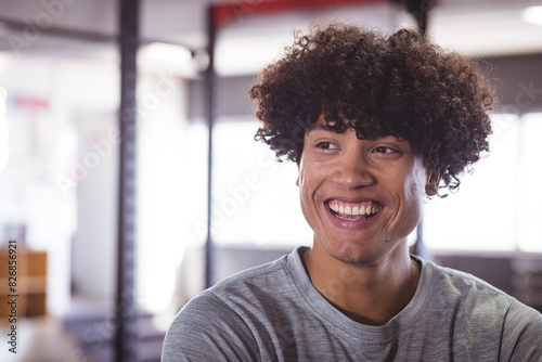 Young biracial man at gym smiling brightly, copy space photo