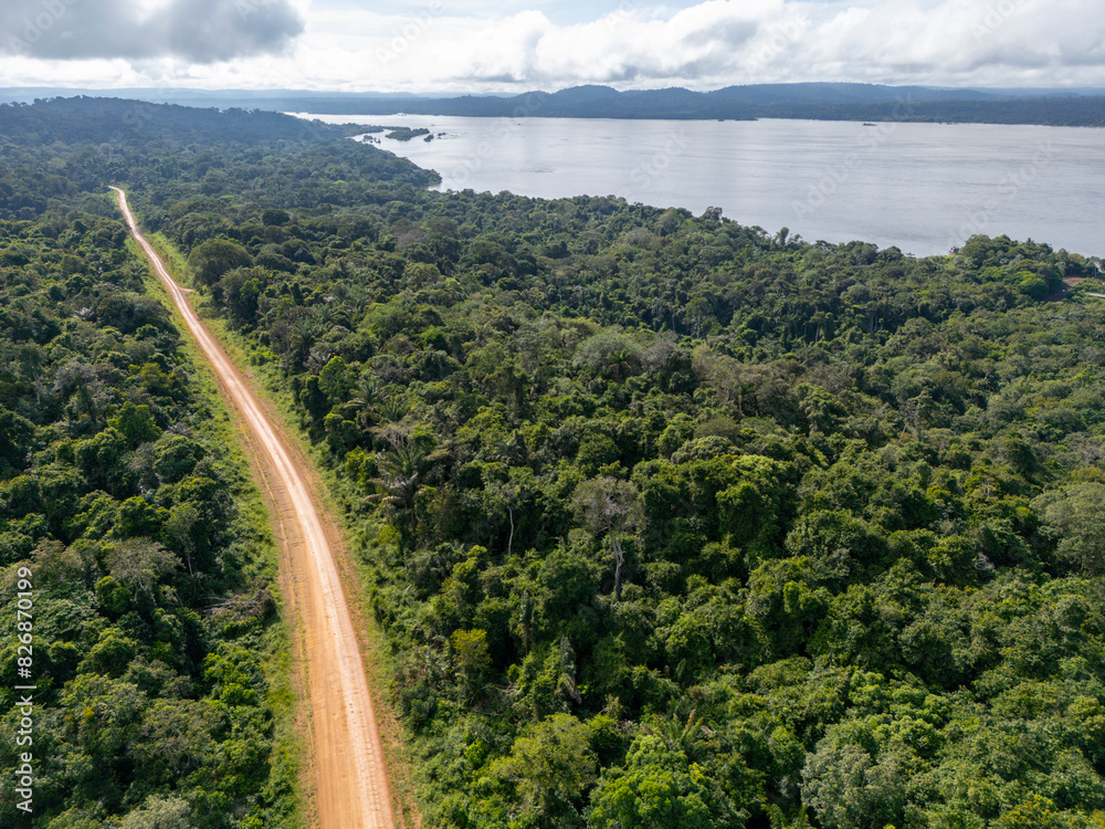 Aerial view of the Trans-Amazonian highway cutting through the dense ...