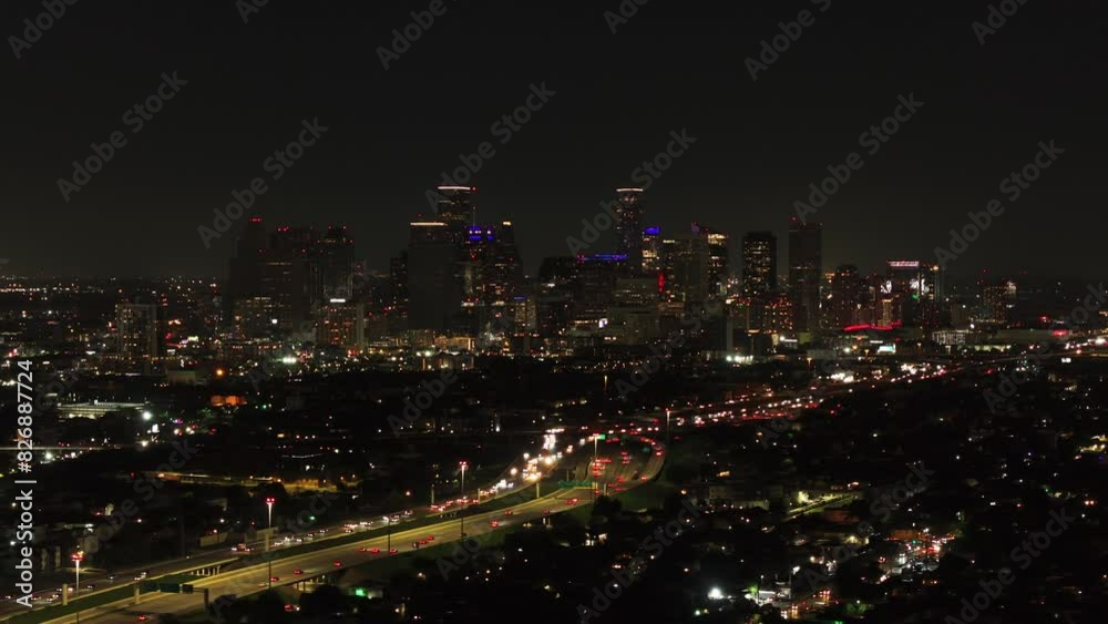 Breathtaking aerial view of Houston's lively downtown skyline at night, featuring city lights and bustling traffic on highways below Breathtaking aerial view of Houston's lively downtown skyline at night, featuring city lights and bustling traffic on highways below