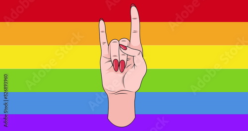 Image of caucasian hand with red nails making rock horns sign over rainbow stripe background