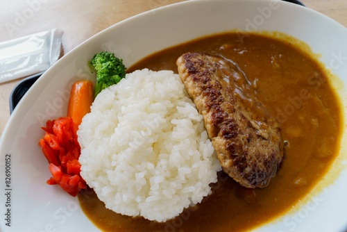 Hamberg with curry and rice on white plate photo