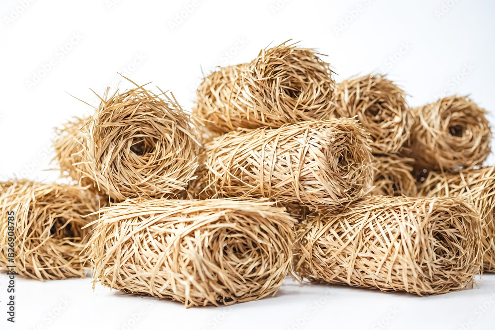 Close up of hay bales isolated on white background. The hay is arranged in a pile, and the background is a clean white. Close up of hay bales isolated on white background. The hay is arranged in a pile, and the background is a clean white.