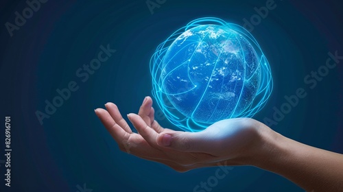 A photorealistic image of a hand holding a glowing blue orb. The orb resembles a miniature Earth with continents and oceans faintly visible. Delicate blue lines resembling circuit paths trace across