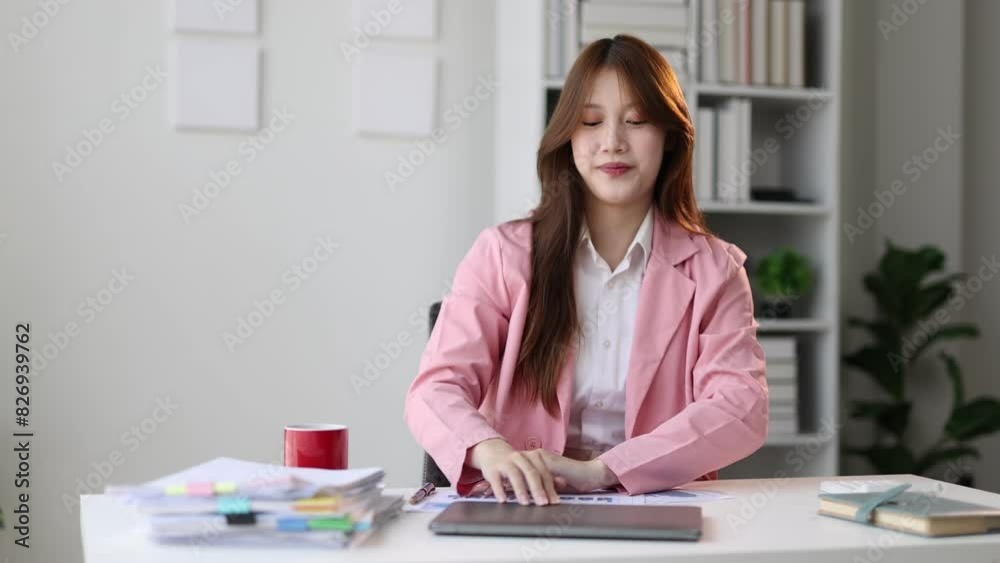 Happy Asian businesswoman doing stretches to relax after long hours of sitting in the office. Happy Asian businesswoman doing stretches to relax after long hours of sitting in the office.
