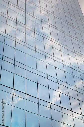 The glass exterior of the tall building