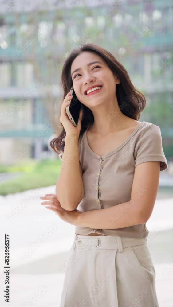 Close up young asian businesswoman talking on the mobile phone smile at summer day Close up young asian businesswoman talking on the mobile phone smile at summer day