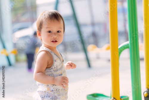 Portrait of Asian little boy enjoying various playful activities at the playground, Children with sweet, cute and bright smiles, in summer or spring, close up photos of happy child aged one year old. © Kanthita