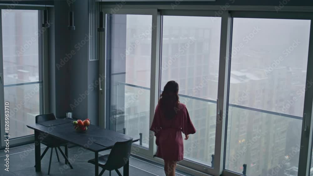 Relaxed model stepping kitchen looking window high angle view. Woman morning Relaxed model stepping kitchen looking window high angle view. Woman morning