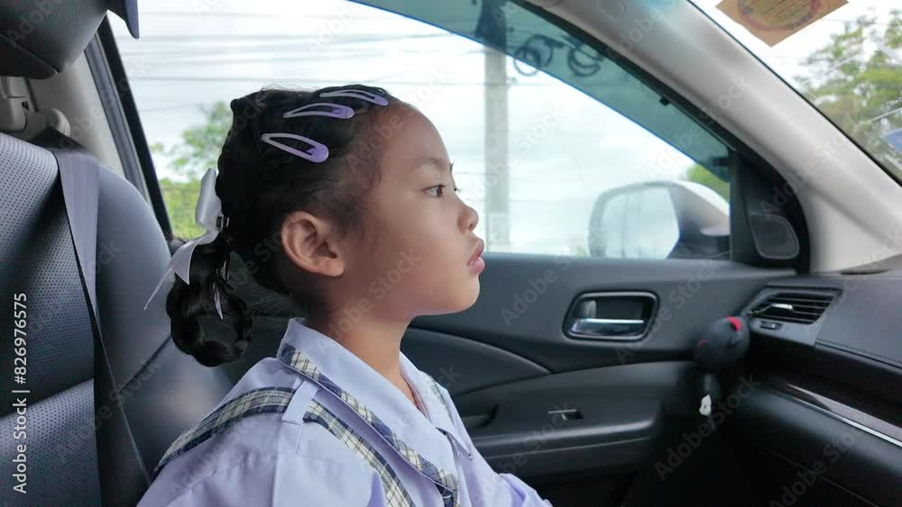 School girl sitting in the passenger seat in car to school. School girl sitting in the passenger seat in car to school.