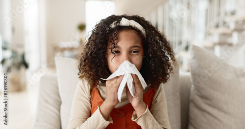 Sick girl, sofa and blowing nose with tissue for virus, infection or congestion in living room at home. Young female person, child or kid with cold, flu or sinus in fatigue, fever or sneeze at house